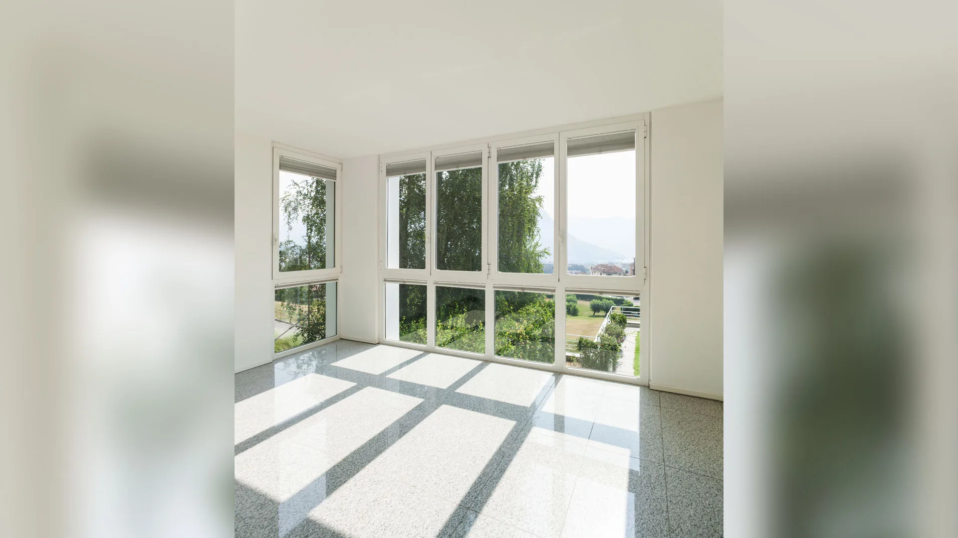 Large installed windows bringing natural light into a residential room